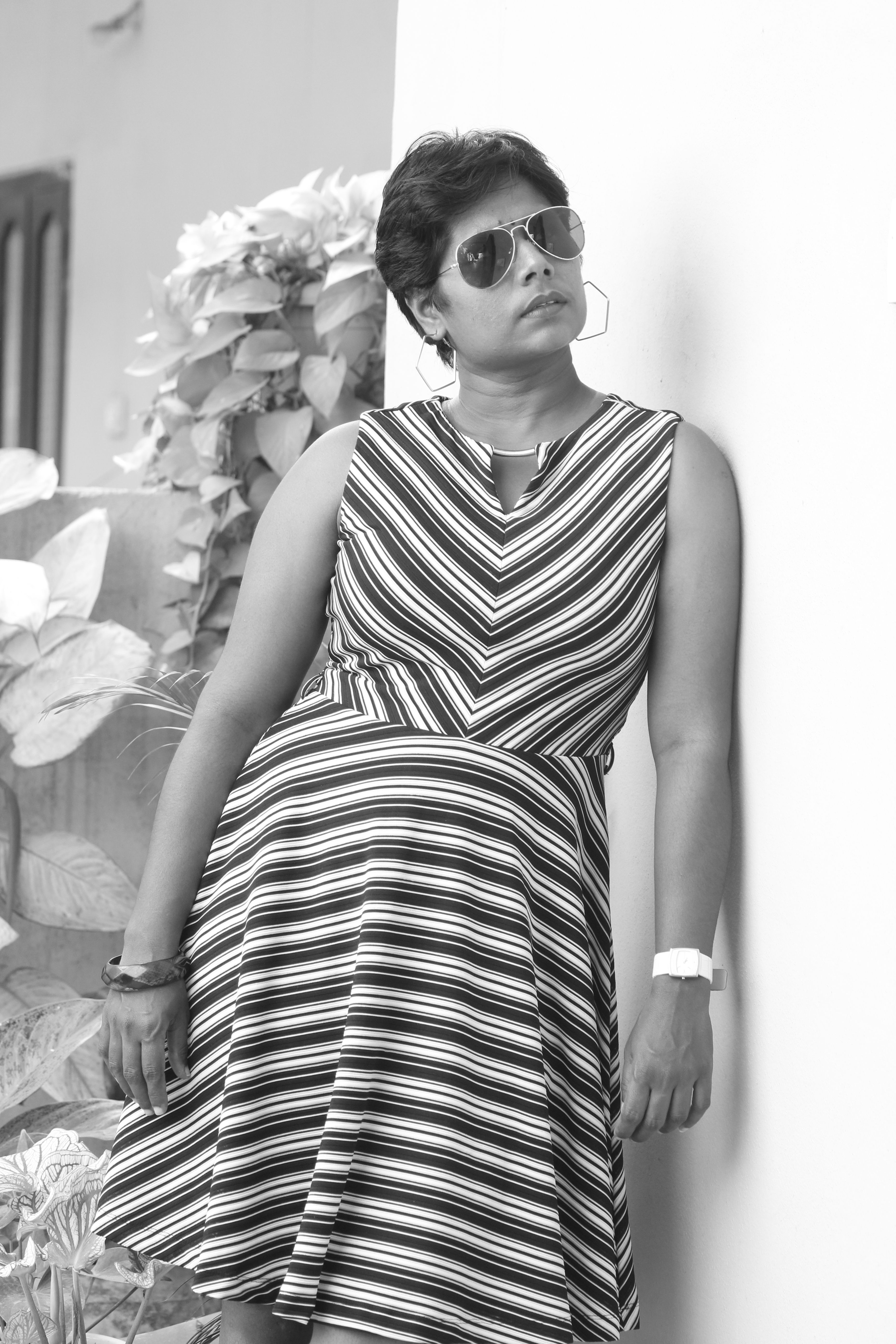 Black and White Shot of a Woman in a Striped Dress · Free Stock Photo
