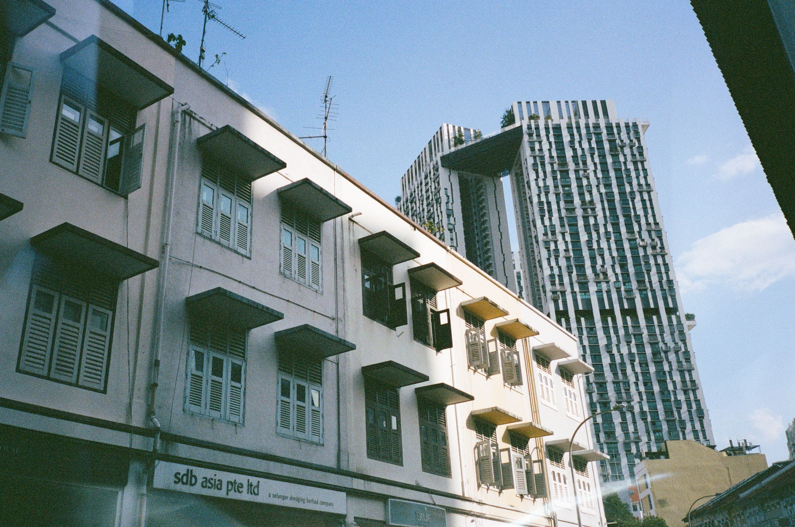 A striking mix of traditional and modern buildings under a clear blue sky.
