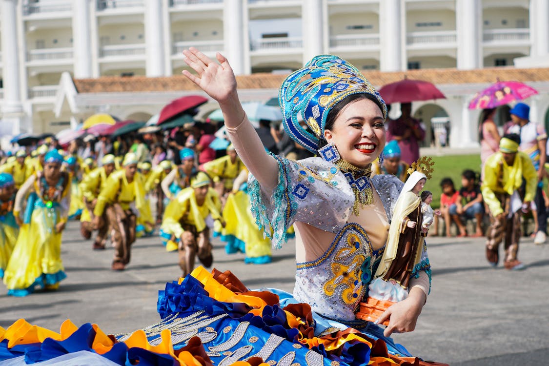 Female Dancer Waving and Smiling During a Parade