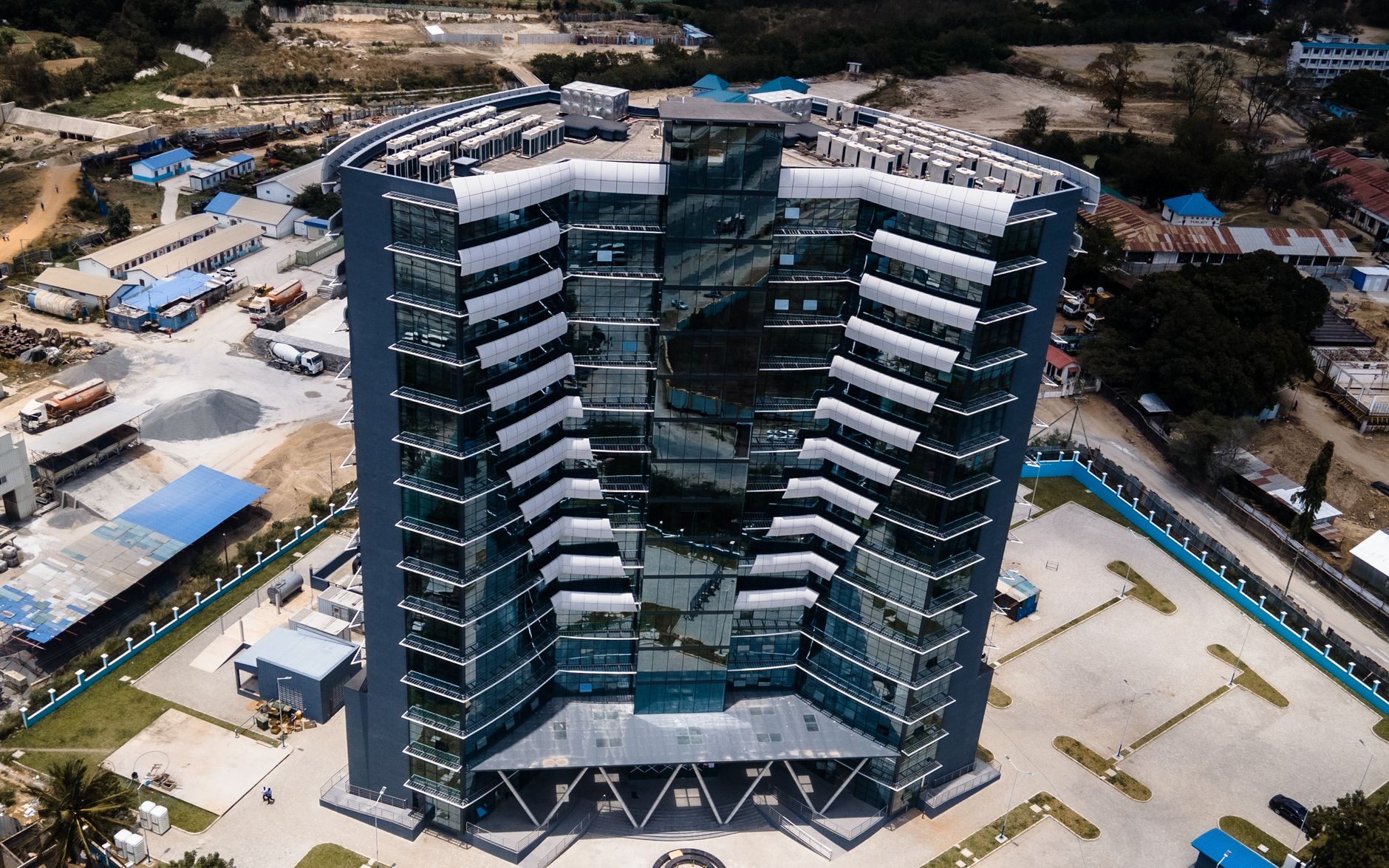 Aerial photograph of a modern skyscraper in Dar es Salaam, Tanzania, showcasing futuristic architecture.