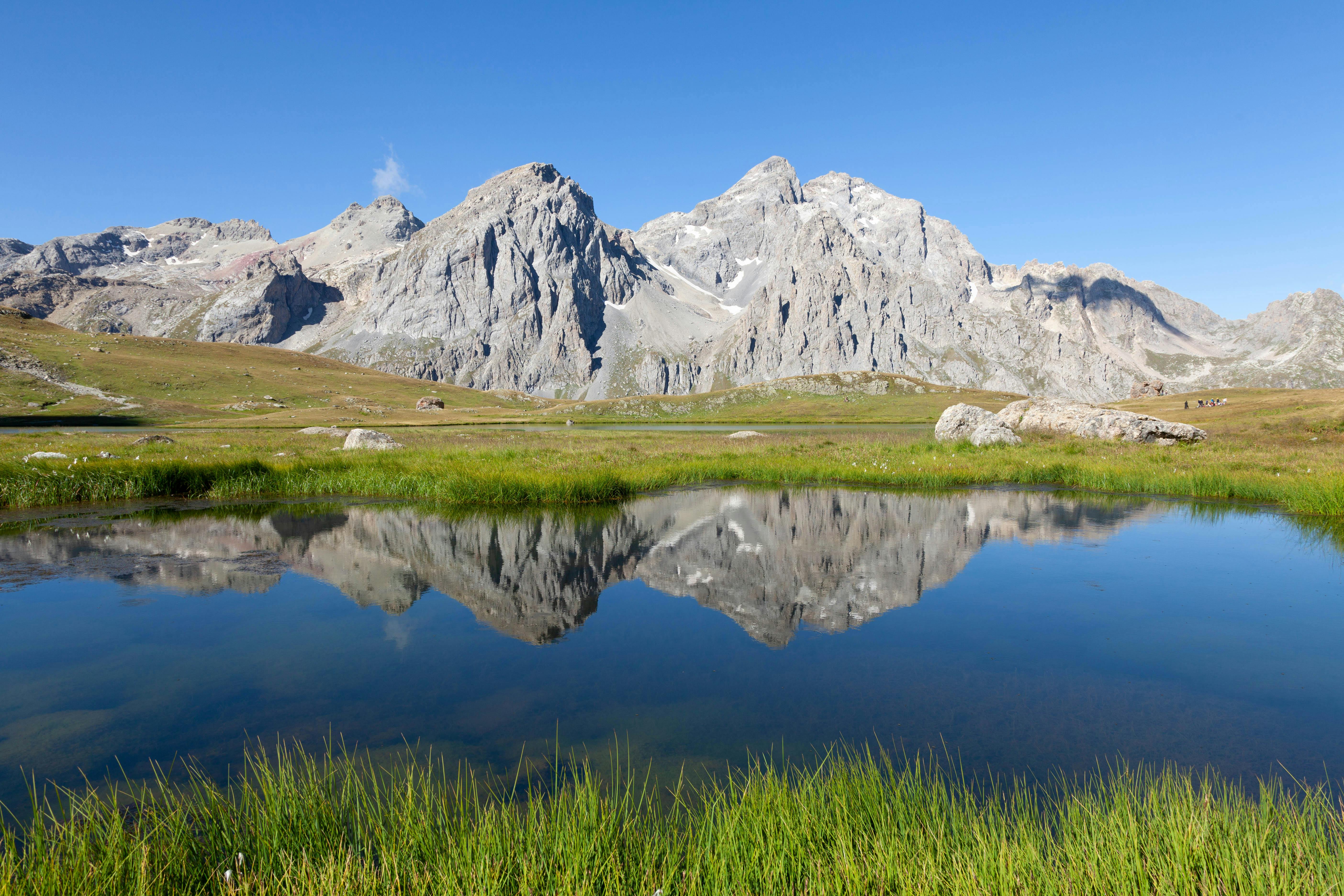 a mountain range with a small pond in the middle