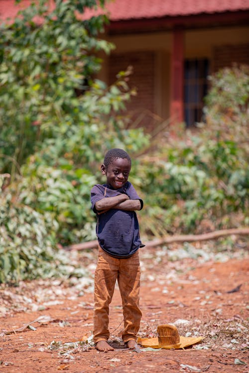 Smiling Little Boy in T-Shirt and Orange Pants