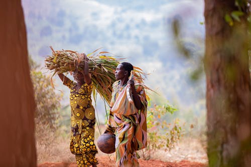 Women in Patterned Dresses in Countryside