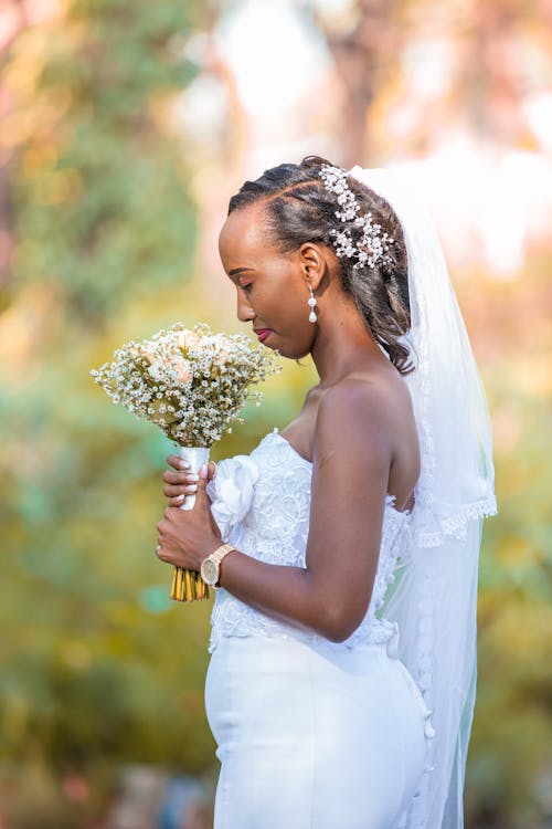 Bride in Wedding Dress and with Flowers Bouquet