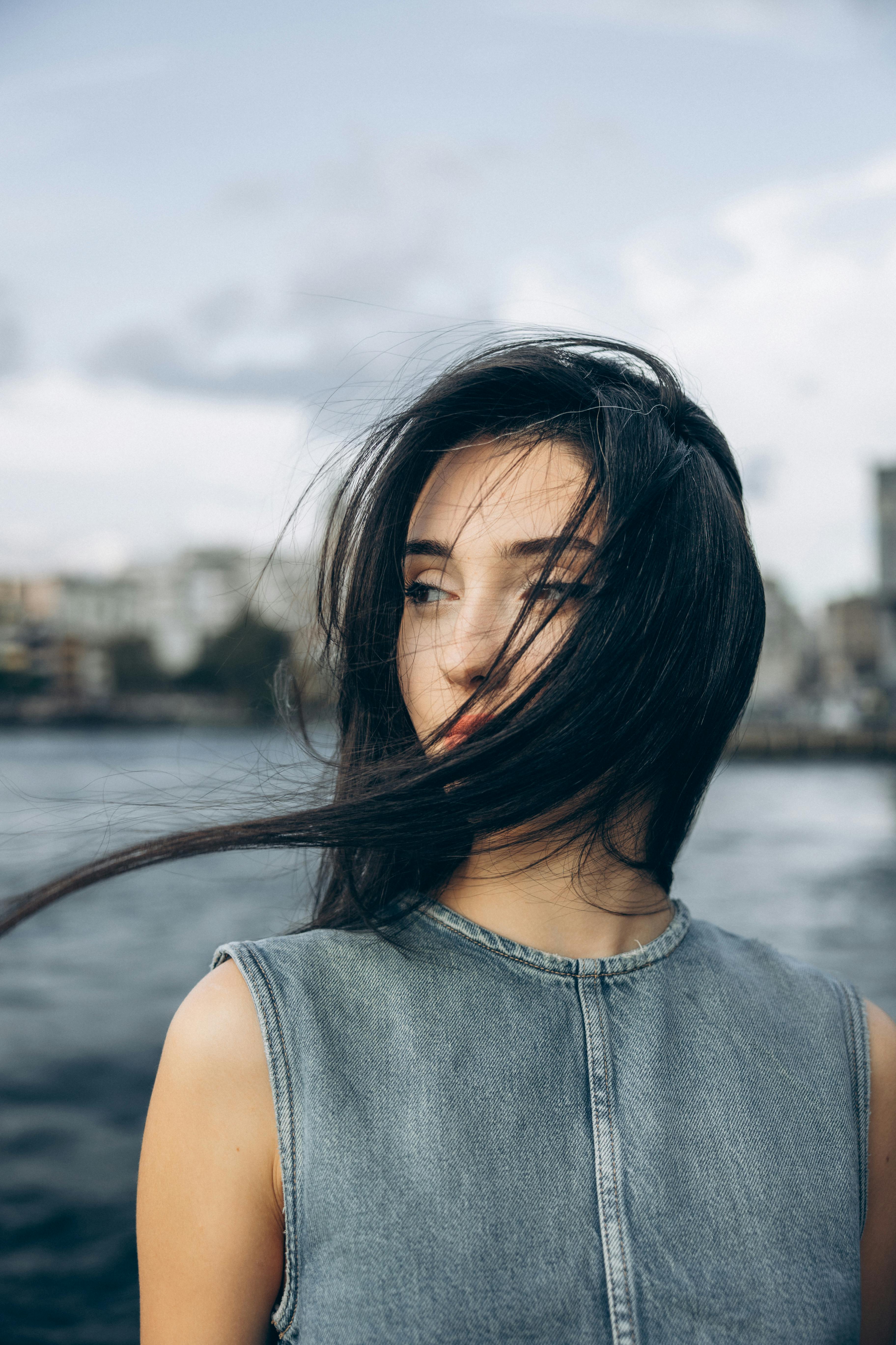 a woman with her hair blowing in the wind