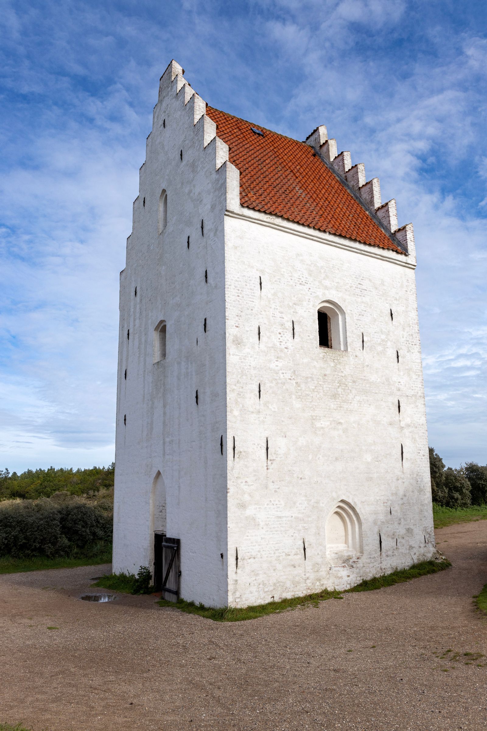 Sand-covered church tower rising from dunes near Skagen on Denmark's northern tip