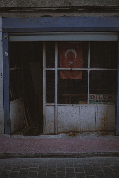 Free An abandoned store with a Turkish flag displayed, reflecting decay and dereliction. Stock Photo