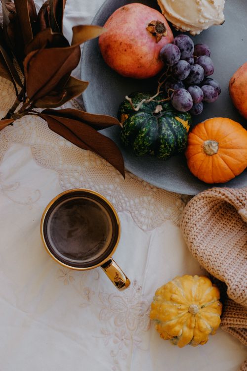 Free Cozy autumn scene with fruits and coffee on a lace-covered table. Stock Photo