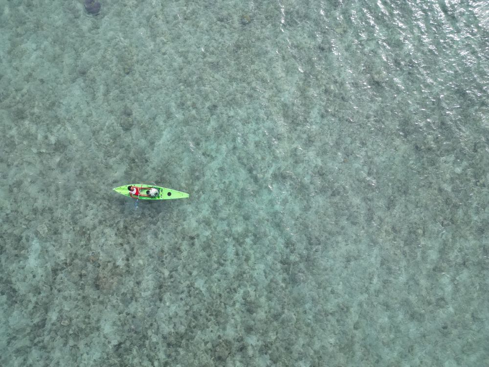 Canoe In Ocean Drone photo of man in the canoe at clear waters of Indian Ocean · Free ...