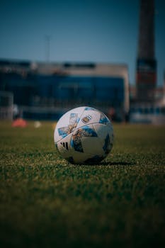 Close-up of a soccer ball on a grassy field in San Salvador de Jujuy, Argentina.