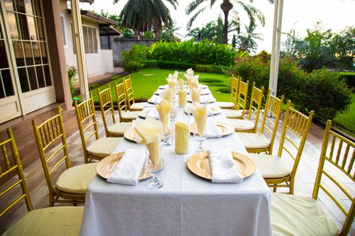 Free Beautifully set outdoor dining table with chairs, perfect for garden events. Stock Photo