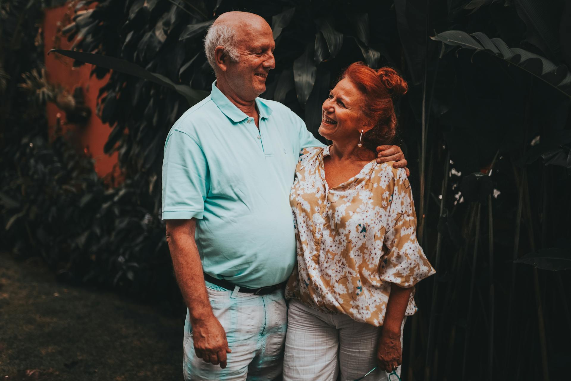 Happy senior couple sharing a loving moment outdoors. Smiling and affectionate.