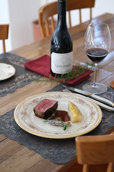 A gourmet meal with steak and red wine set in an elegant dining atmosphere, perfect for luxury dining experiences.