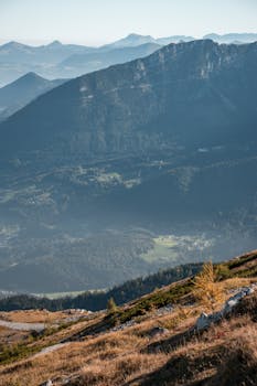 Breathtaking view of Bavaria's mountain ridges with scenic valleys and haze, ideal for mobile wallpaper.