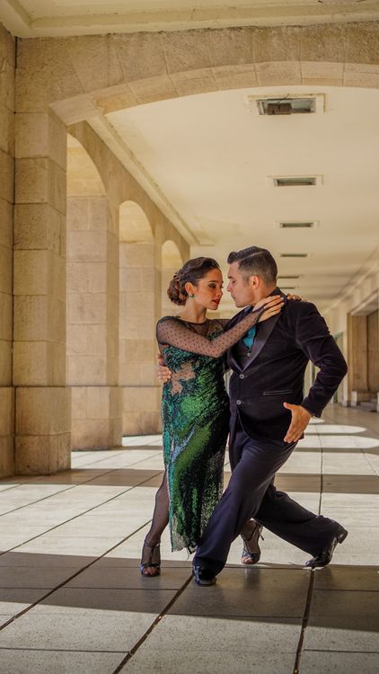 International Standard — couple dancing under arches. Stock photo.