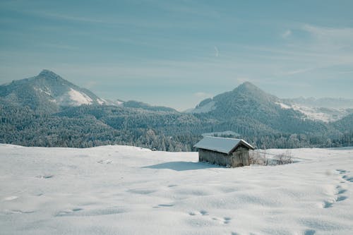 Wooden Hut in Snowy Mountains