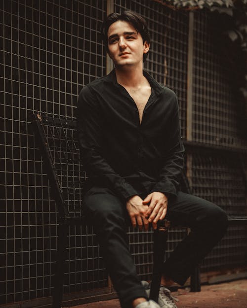 Man in Black Shirt Sitting on Chair