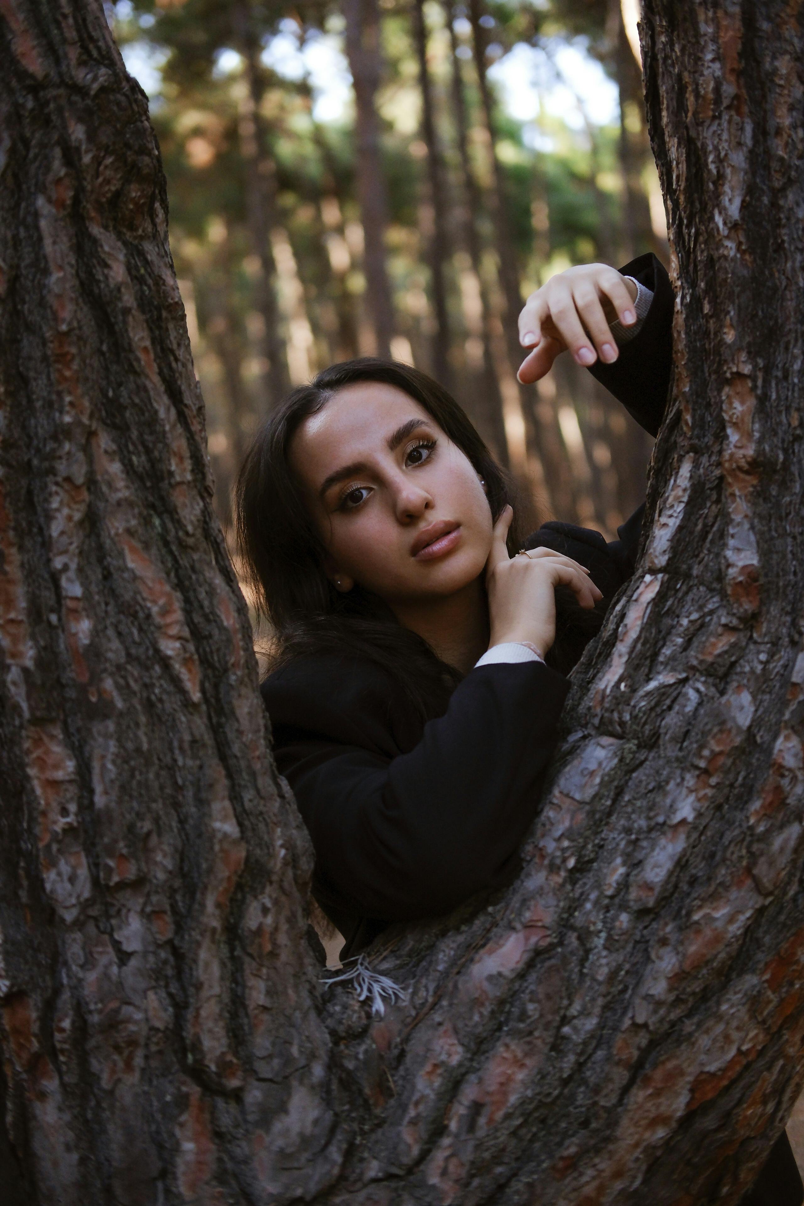 Brunette Model behind Tree · Free Stock Photo