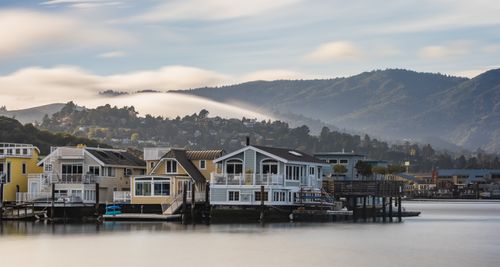 Free Charming houseboats in Sausalito with a serene mountain backdrop during sunrise. Stock Photo