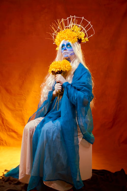 Woman in a Face Painting a Costume Posing in Studio 