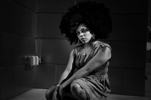 Model with Afro Squatting in Black and White