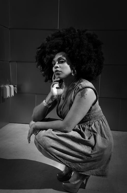 Black and White Photo of a Brunette Woman Posing in Denim Dress