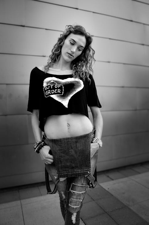 Woman in Black Top Posing on Sidewalk