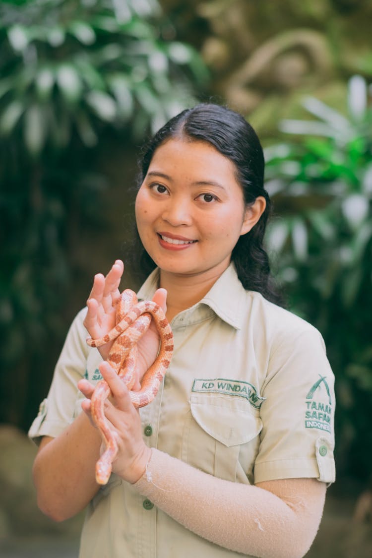 Smiling Zookeeper From The Taman Safari Animal Theme Park Holding A Snake