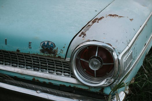 Close-up of a rusty vintage Ford car showcasing age and character.