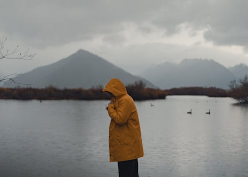 Tourist in a Yellow Raincoat by the Lake Wakatipu