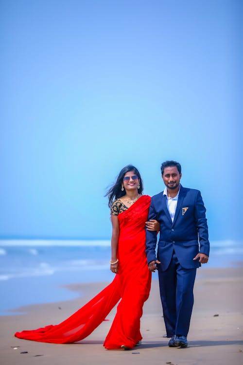 Elegant Couple Walking on a Beach 