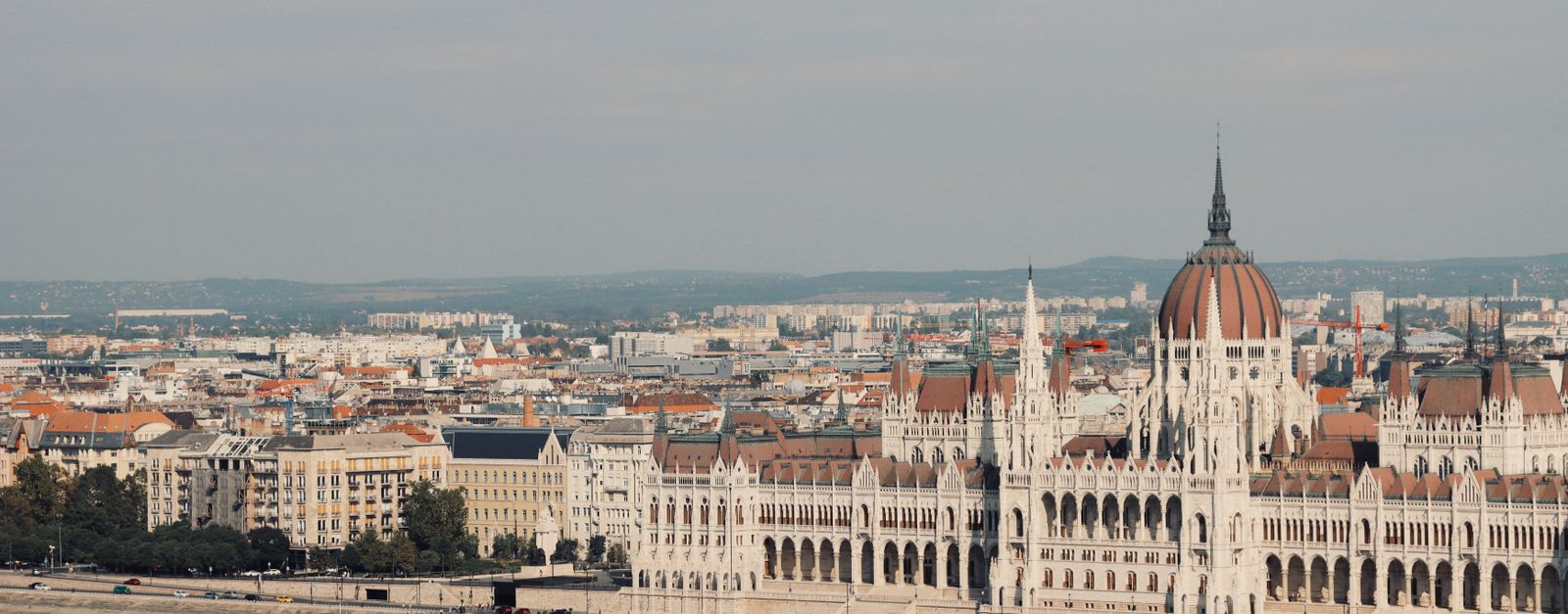Scenic view of the iconic Hungarian Parliament Building along the Danube River in Budapest.