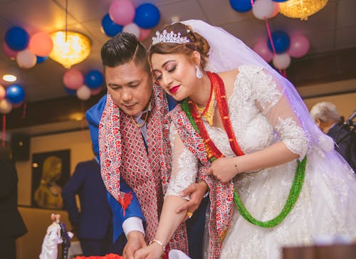 Newlyweds Cutting the Wedding Cake Together