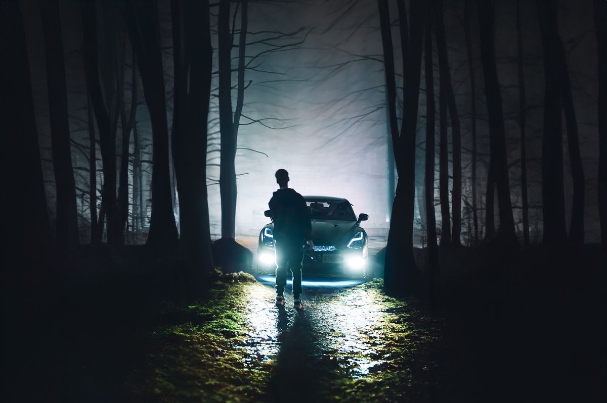 Eerie silhouette in foggy forest at night like a scene from an 80s slasher movie