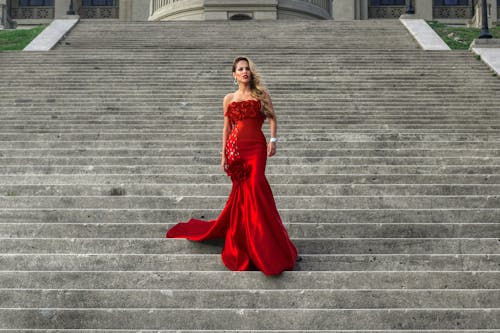 Model in Long Red Dress Posing on Stairs