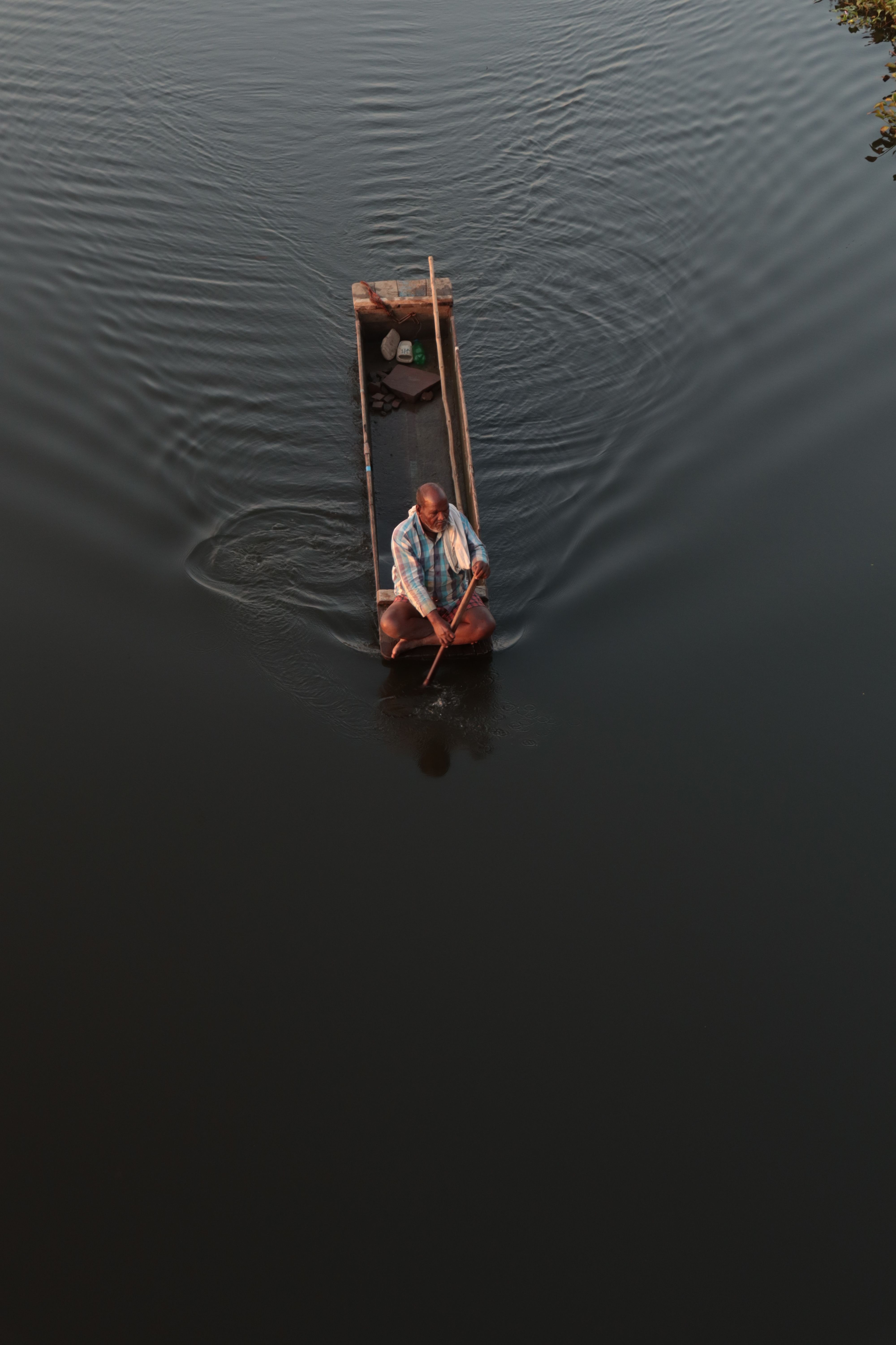 Man Rowing in a Wooden Rectangular Boat · Free Stock Photo
