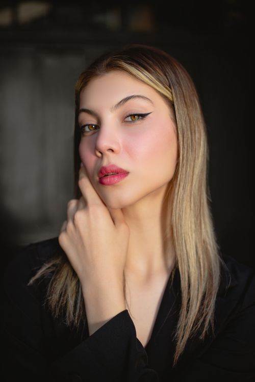 Free Sophisticated portrait of a woman with blonde hair showcasing makeup and style. Stock Photo