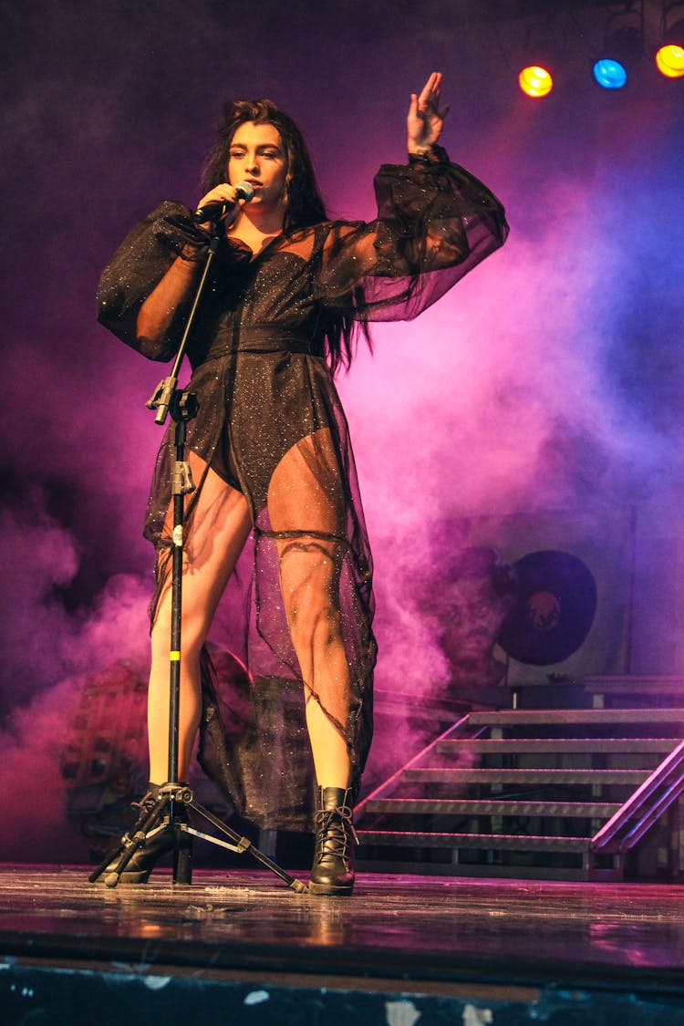 Woman Holding Microphone On Stage