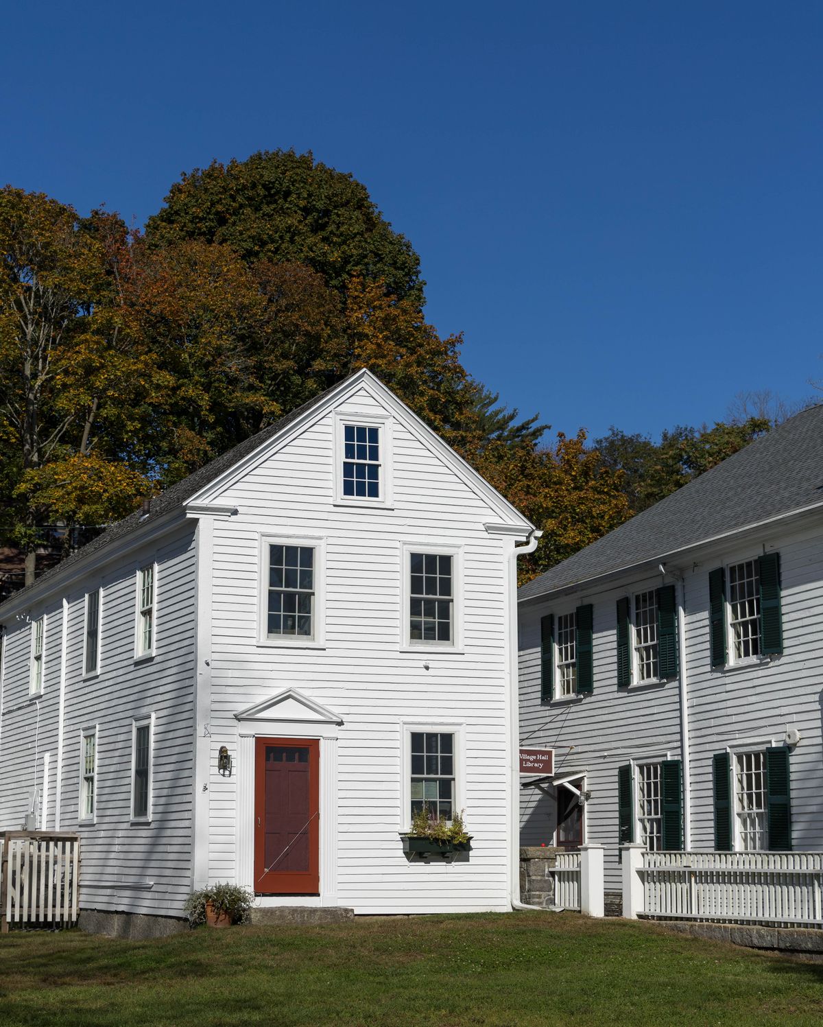 Traditional American home with white siding and shutters