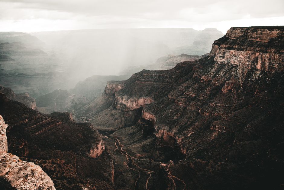 Grand Canyon West Rim Helicopter Tour with Champagne Toast - Breathtaking view of the Grand Canyon shrouded in mist, highlighting its majestic beauty and mystery.