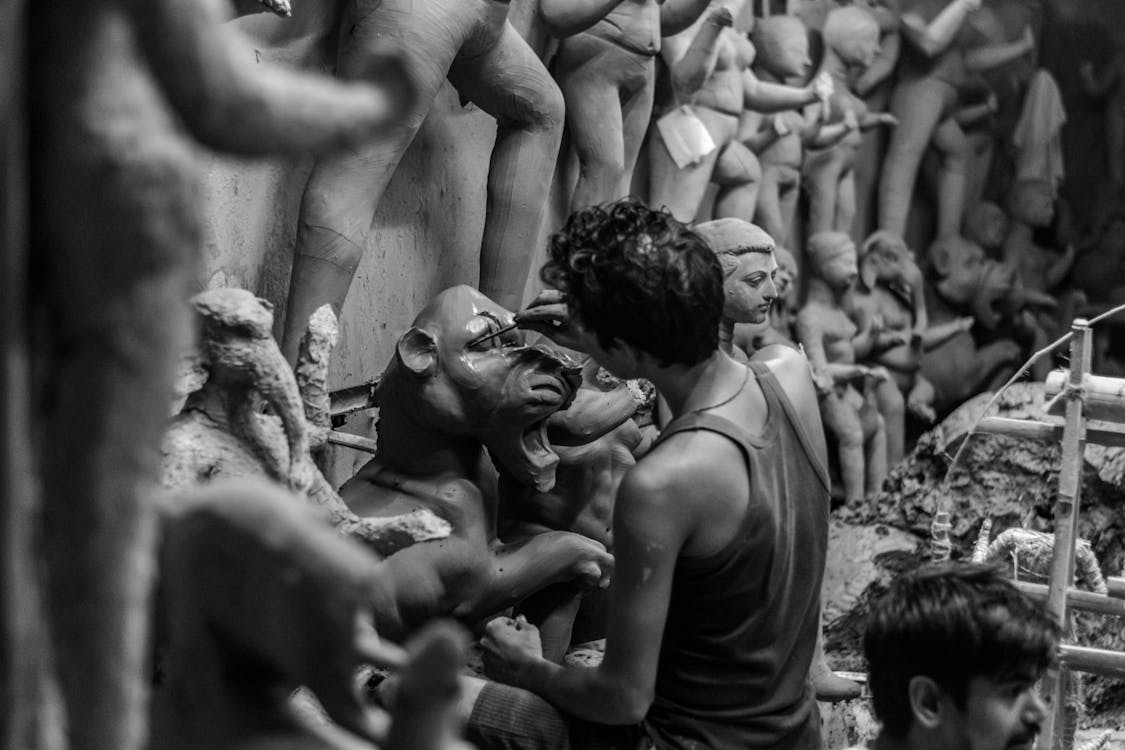 Vibrant scene of artisans crafting Durga idols in West Bengal, India, embodying tradition, culture, and creativity in the heart of the community.