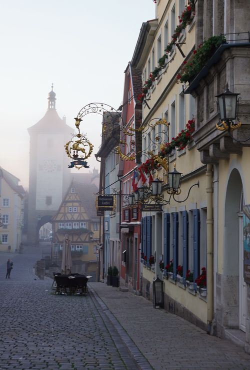 Free A foggy morning view of a historic cobblestone street in Rothenburg ob der Tauber, Germany. Stock Photo