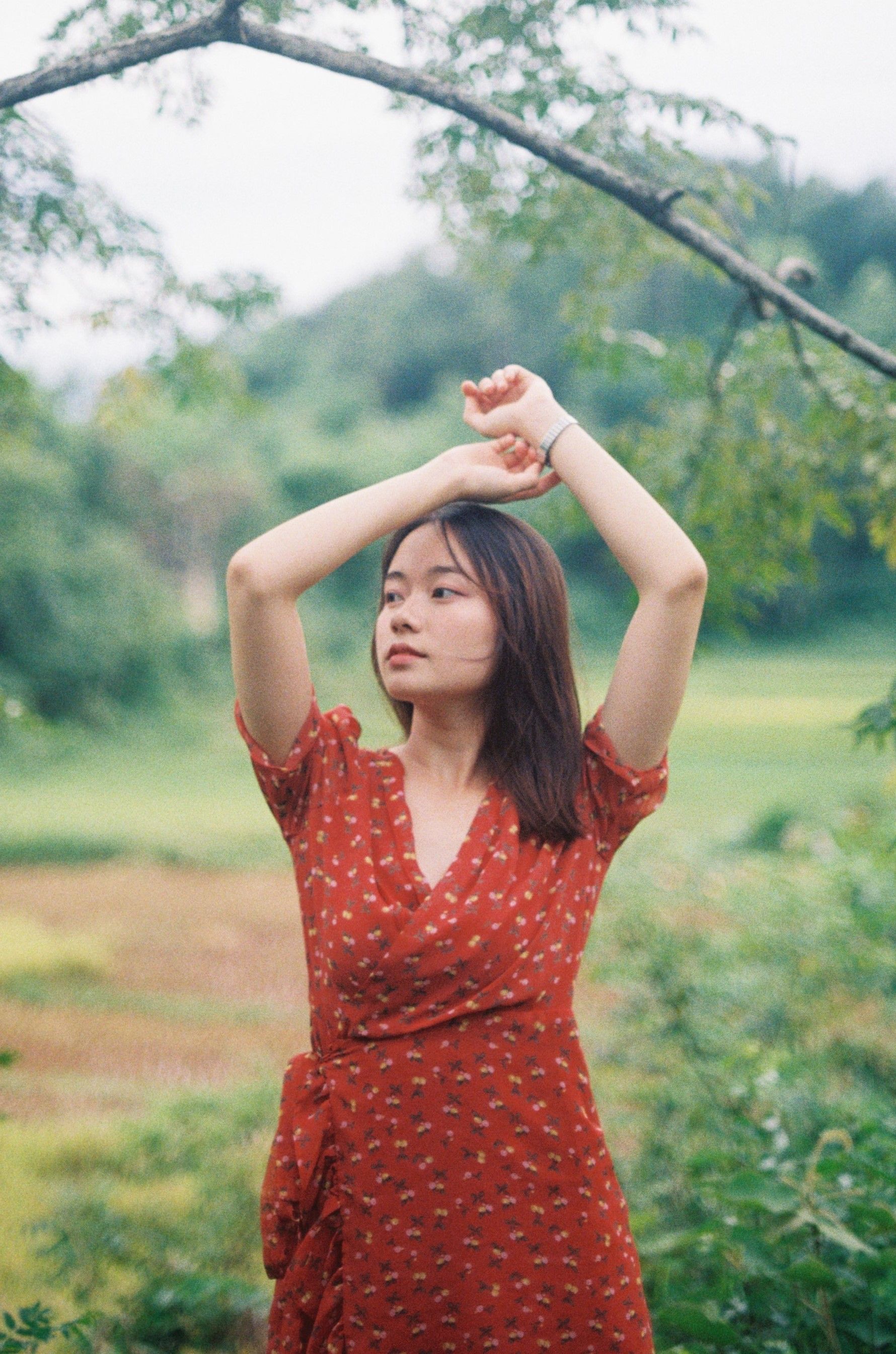 Woman in Red Sundress Standing with Eyes Closed  Free Stock Photo