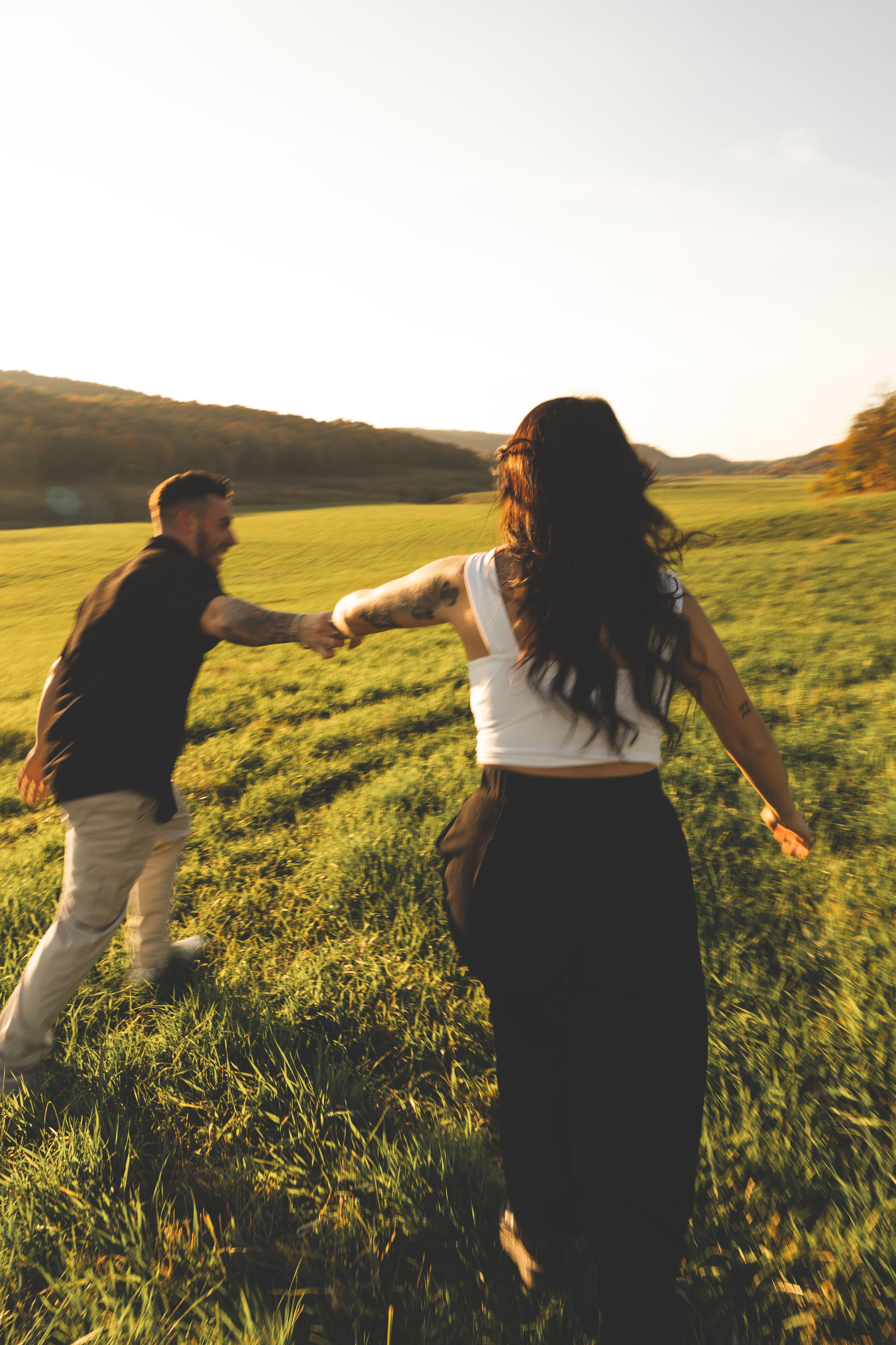 Couple Holding Hands on Grassland · Free Stock Photo