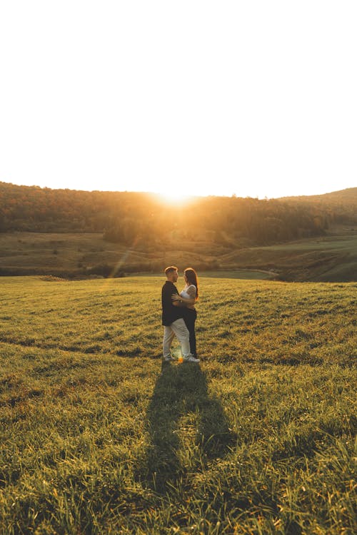 Couple on Grassland at Sunset