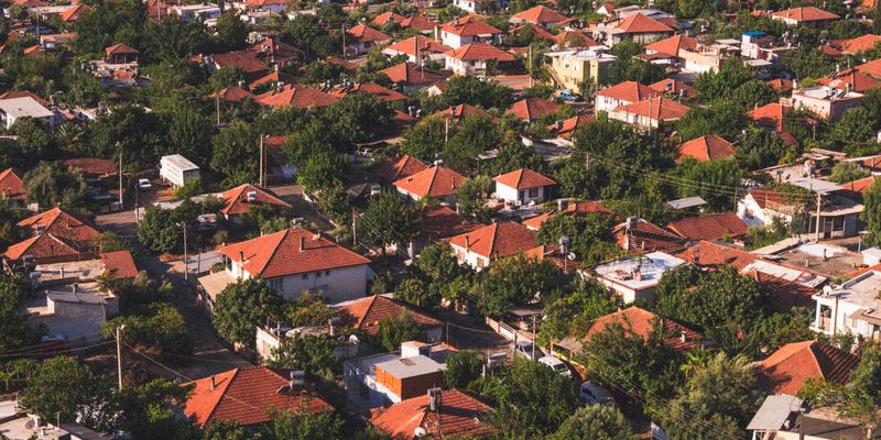 Aerial view of suburban neighborhood with red-tiled roofs