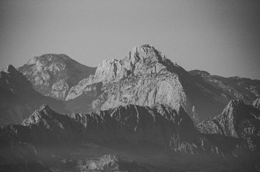 Monochrome view of a rugged mountain range capturing natural erosion patterns.