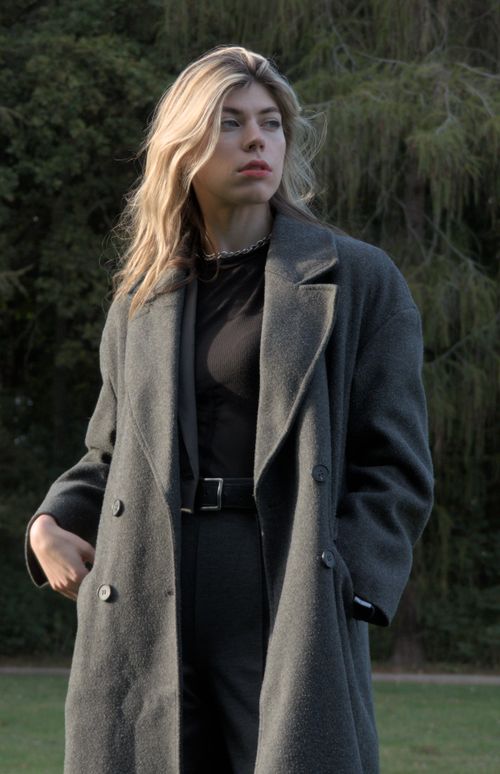 Free Caucasian woman with blonde hair in a khaki coat, standing outdoors, exuding fashion and elegance. Stock Photo