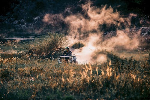 A Person Riding on a Quad Bike on a Field 