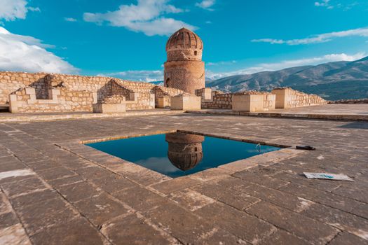Scenic view of Zeynel Bey Tomb with reflection in Hasankeyf, showcasing historical architecture.